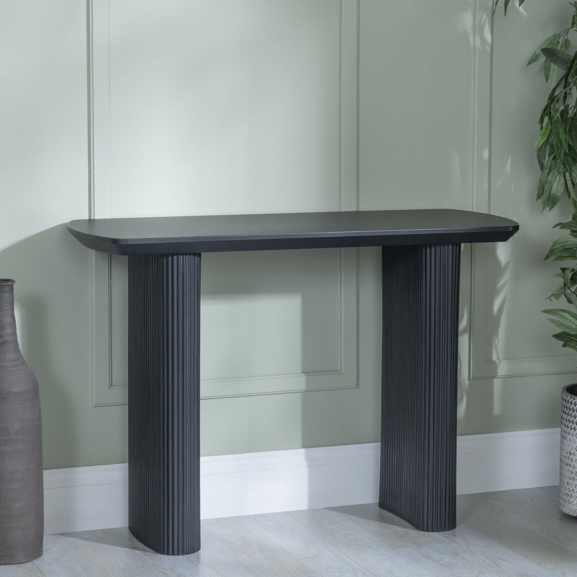 Renzo Black Oval Console Table with Fluted Ribbed Drum Base